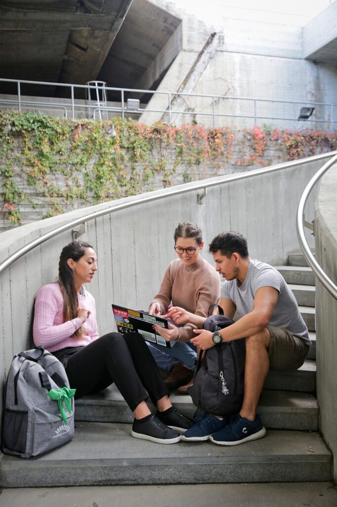 Group of people sit on stairs and chat