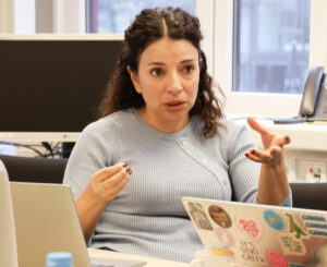 Person talking at a table.