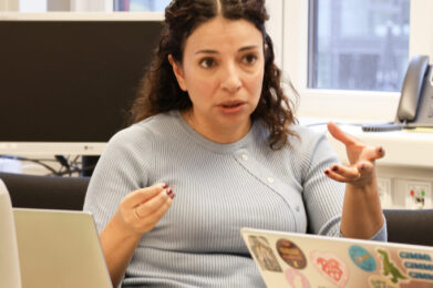 Person talking at a table.
